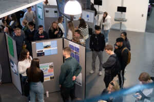 Students looking at posters during an event.