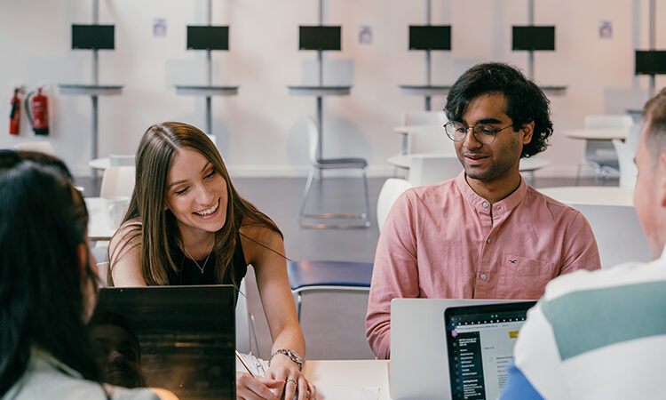 Students sitting around a computer